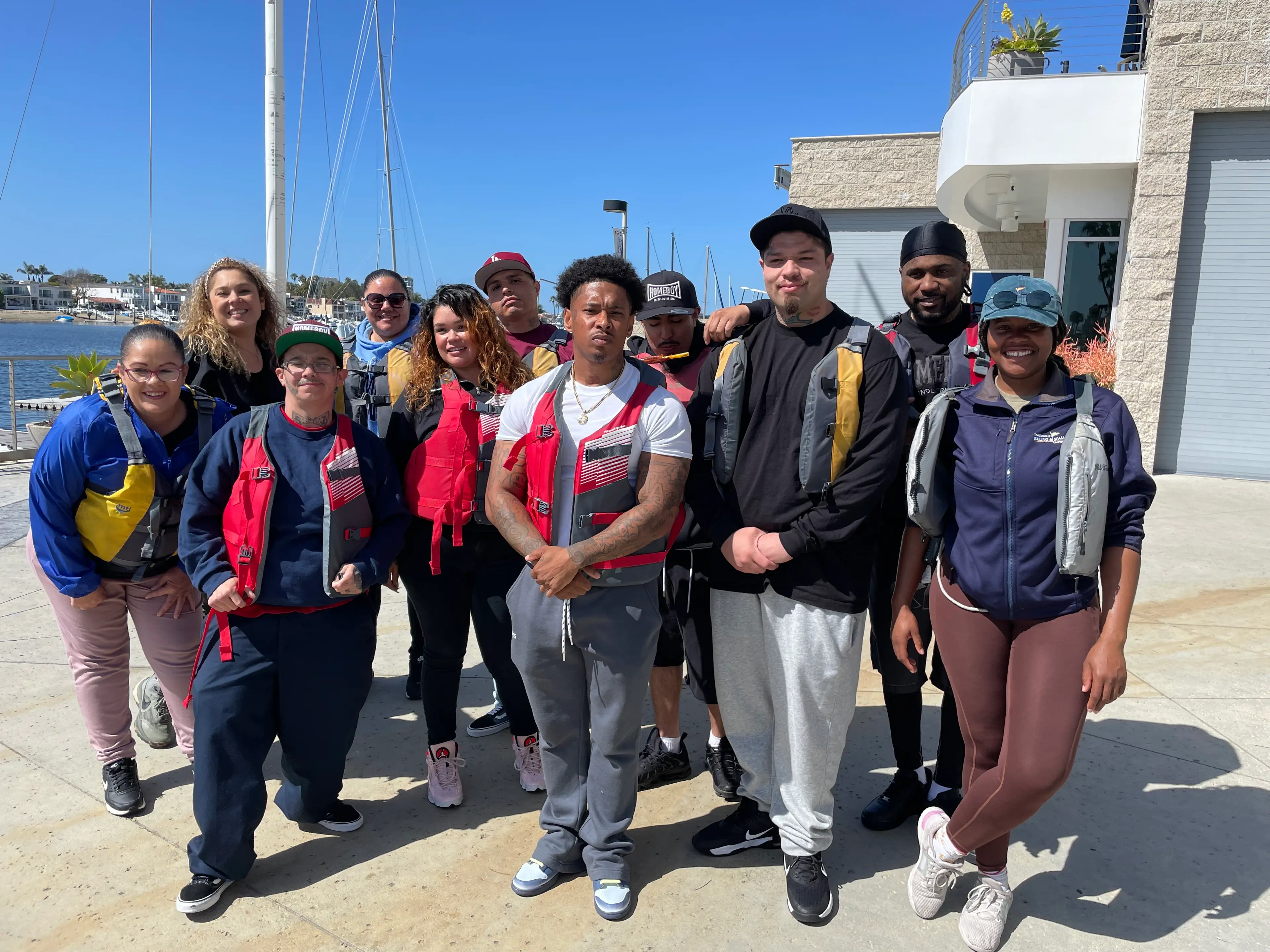 Outside the City participants in life jackets on the dock at the Orange Coast College sailing base in Newport Harbor