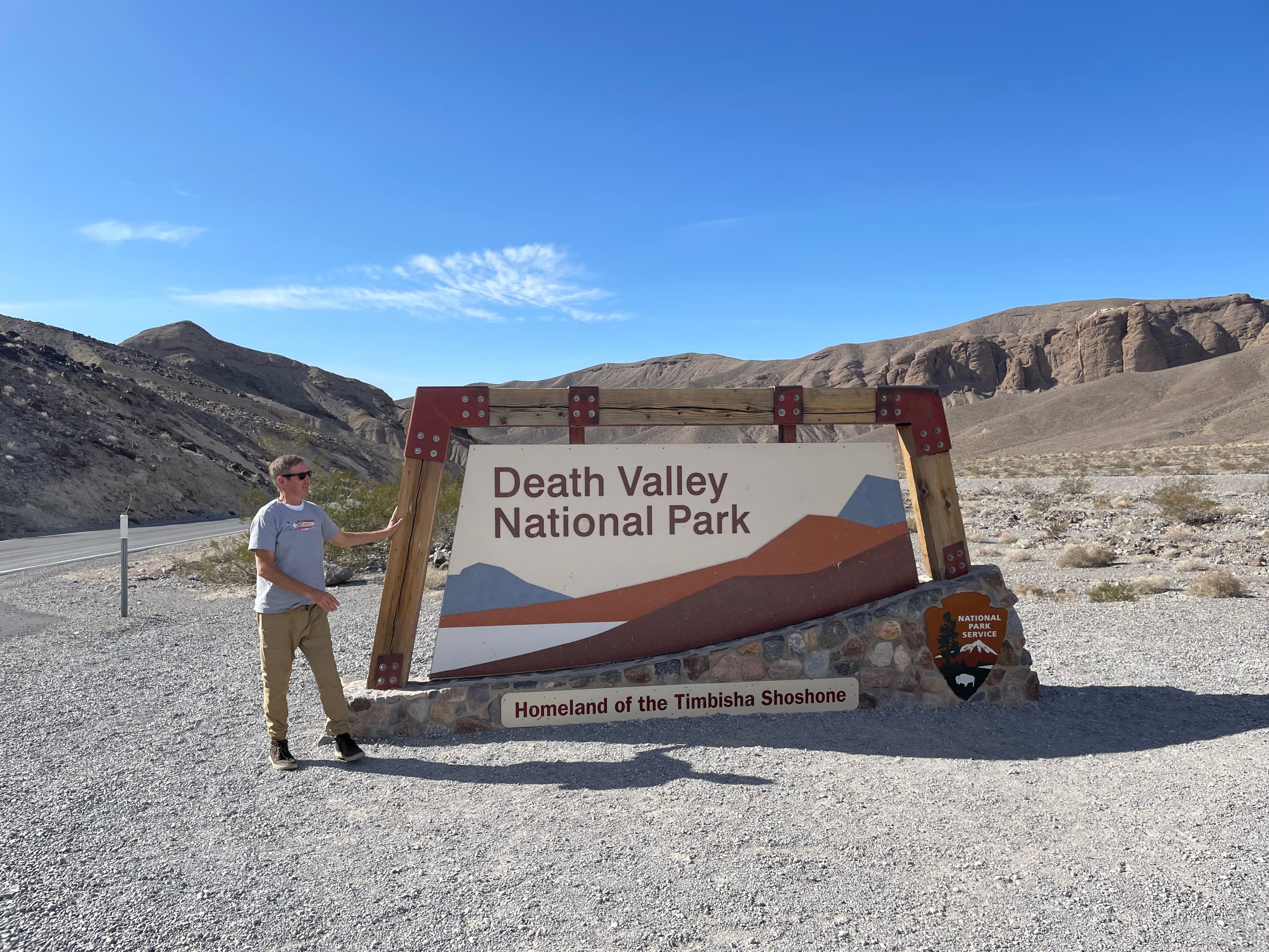 Team member at the Death Valley National Park entrance sign